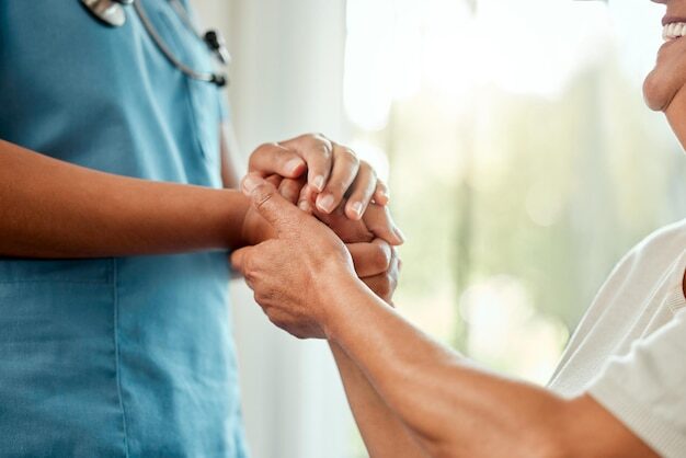 Holding hands support and nurse with woman for help at assisted living facility for checkup Happy medical and healthcare caregiver with senior female patient for comfort empathy or gratitude